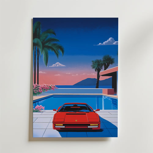 En Retro 80s Ferrari Hiroshi Poster by Bozetto föreställer en röd sportbil parkerad vid en pool, omgiven av palmer och blommor, med ett modernt hus, stilla hav och berg i solnedgång i bakgrunden - allt i en lyxigt matt yta och högkvalitativ finish.