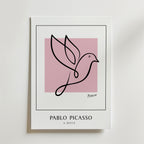 Picasso Bird of Hope Poster från Bozetto visar minimalistisk linjekonst av en duva över en rosa kvadrat. Nedanför är "PABLO PICASSO" och "A DOVE" tryckta i feta svarta versaler.