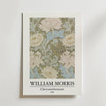 Bozetto William Morris Chrysanthemum Poster visar den intrikata blomsterdesignen från 1876 i mjukt grönt, krämfärgat och blått på en himmelsblå bakgrund med texten "WILLIAM MORRIS Chrysanthemum 1876" under bilden.